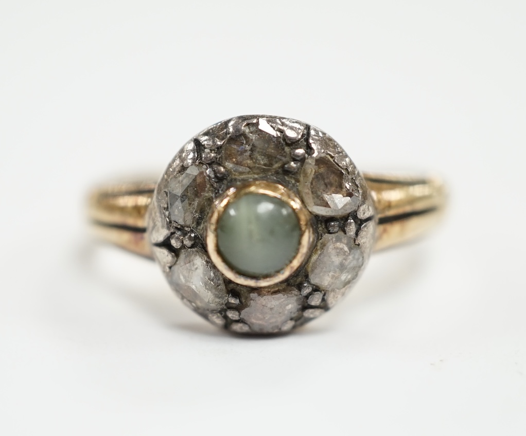 An early 20th century 18ct, cat's eye chrysoberyl and rose cut diamond set circular cluster ring, size M, gross weight 4.6 grams.